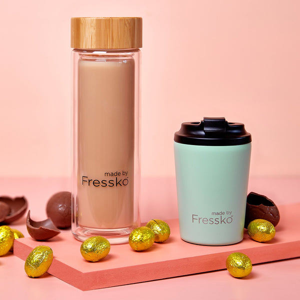 Fressko glass flask filled with mocha and camino coffee cup surrounded with chocolate eggs